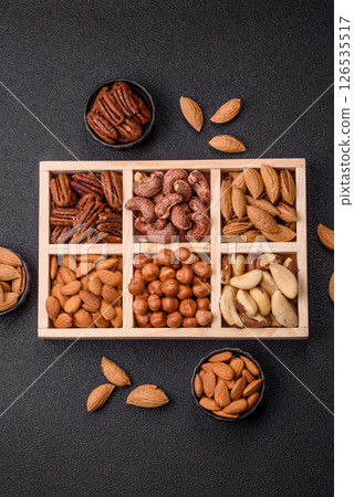 Wooden box with nuts cashew, hazelnut, almond, brazil, pecan, walnut 126535517