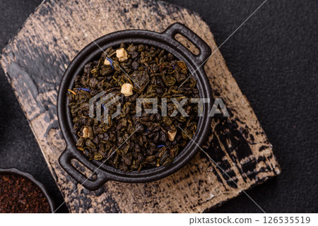 Dry green tea with soursop piece, knapweed petals in bowl 126535519