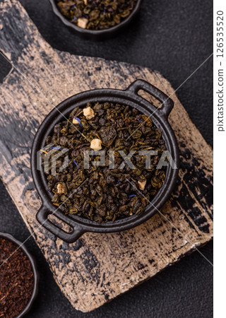 Dry green tea with soursop piece, knapweed petals in bowl 126535520
