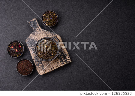 Dry green tea with soursop piece, knapweed petals in bowl 126535523