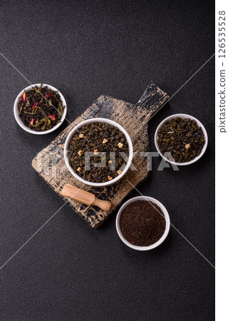 Dry green tea with soursop piece, knapweed petals in bowl Dry green tea with soursop piece, knapweed petals in bowl 126535528