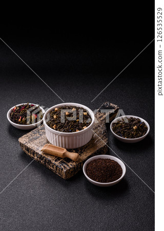 Dry green tea with soursop piece, knapweed petals in bowl Dry green tea with soursop piece, knapweed petals in bowl 126535529