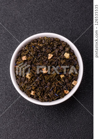 Dry green tea with soursop piece, knapweed petals in bowl Dry green tea with soursop piece, knapweed petals in bowl 126535535