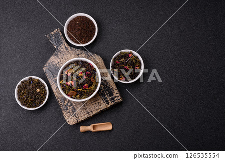 Dry tea mix blend black, green and flower petals in bowl 126535554