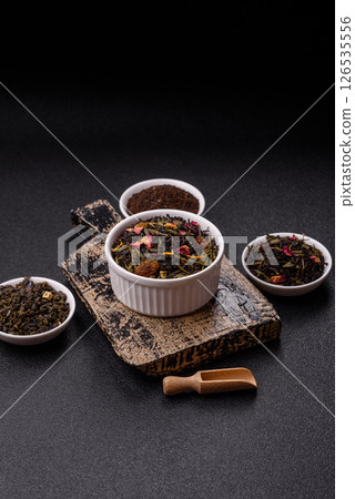 Dry tea mix blend black, green and flower petals in bowl Dry tea mix blend black, green and flower petals in bowl 126535556