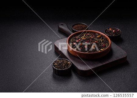 Dry tea mix blend black, green and flower petals in bowl Dry tea mix blend black, green and flower petals in bowl 126535557