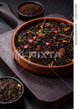 Dry tea mix blend black, green and flower petals in bowl Dry tea mix blend black, green and flower petals in bowl 126535564