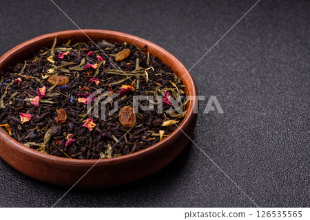 Dry tea mix blend black, green and flower petals in bowl Dry tea mix blend black, green and flower petals in bowl 126535565