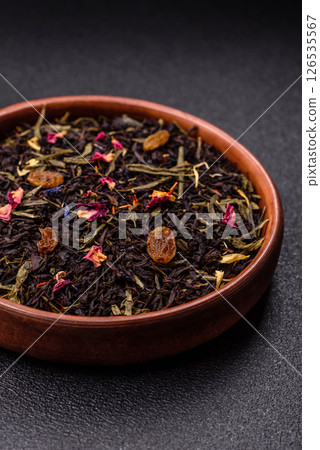 Dry tea mix blend black, green and flower petals in bowl Dry tea mix blend black, green and flower petals in bowl 126535567