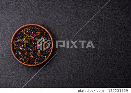 Dry tea mix blend black, green and flower petals in bowl 126535569