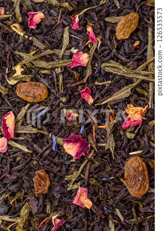 Dry tea mix blend black, green and flower petals in bowl Dry tea mix blend black, green and flower petals in bowl 126535573
