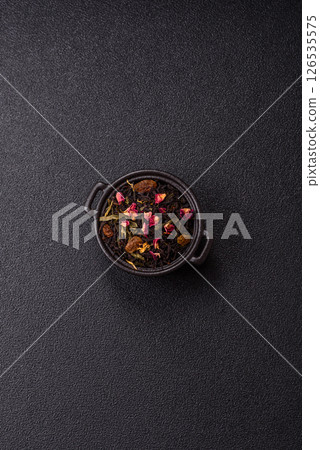 Dry tea mix blend black, green and flower petals in bowl 126535575