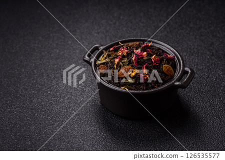 Dry tea mix blend black, green and flower petals in bowl Dry tea mix blend black, green and flower petals in bowl 126535577
