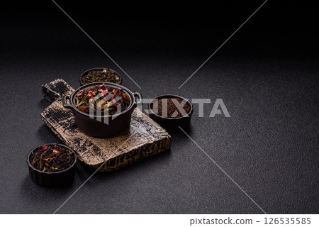 Dry tea mix blend black, green and flower petals in bowl Dry tea mix blend black, green and flower petals in bowl 126535585
