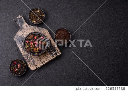 Dry tea mix blend black, green and flower petals in bowl Dry tea mix blend black, green and flower petals in bowl 126535586