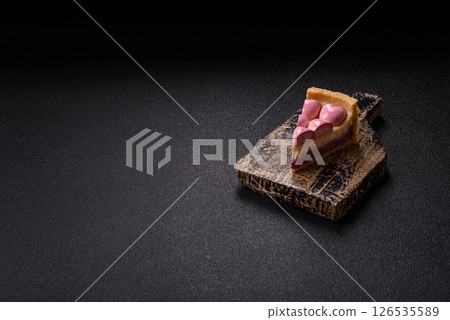 Sweet cheesecake with berry flavor, decorated with pink hearts 126535589