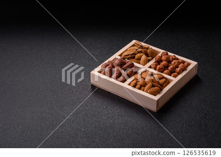 Wooden box with four sections filled with nuts Wooden box with four sections filled with nuts 126535619