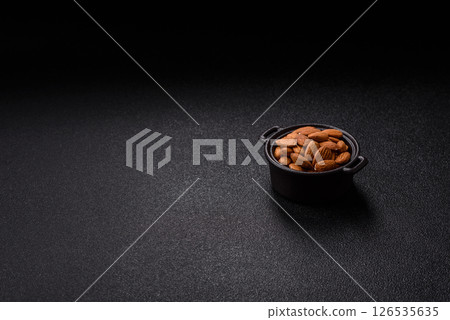 Roasted or raw peeled almonds in bowl Roasted or raw peeled almonds in bowl 126535635