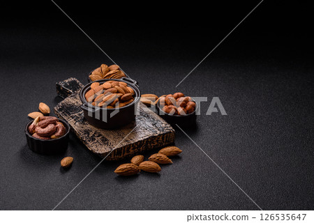 Roasted or raw peeled almonds in bowl 126535647