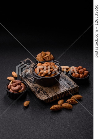 Roasted or raw peeled almonds in bowl 126535650