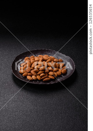 Roasted or raw peeled almonds in bowl Roasted or raw peeled almonds in bowl 126535654