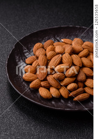 Roasted or raw peeled almonds in bowl 126535658
