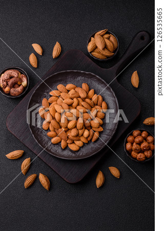 Roasted or raw peeled almonds in bowl Roasted or raw peeled almonds in bowl 126535665