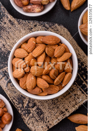 Roasted or raw peeled almonds in bowl 126535677