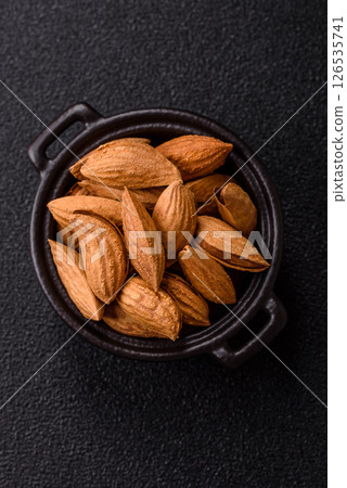 Roasted or raw almond nuts in shell in bowl Roasted or raw almond nuts in shell in bowl 126535741