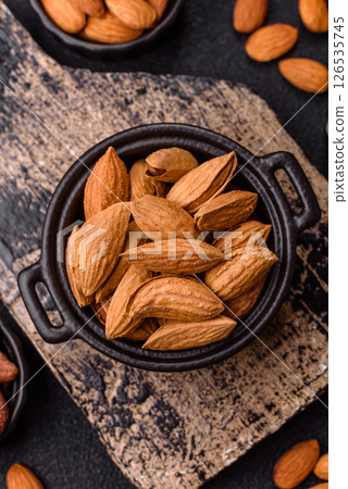 Roasted or raw almond nuts in shell in bowl Roasted or raw almond nuts in shell in bowl 126535745