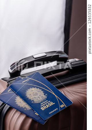 International passport of a citizen of Brasil on a suitcase International passport of a citizen of Brasil on a suitcase 126535832