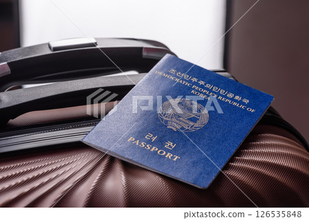 International passport of a citizen of North Korea on a suitcase International passport of a citizen of North Korea on a suitcase 126535848