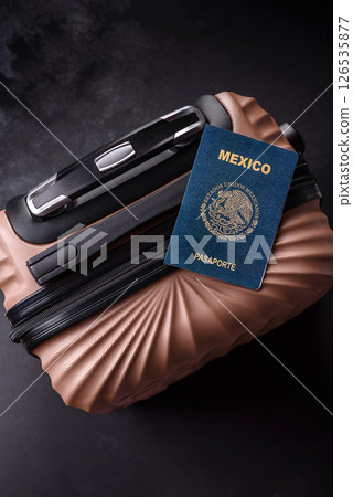 International passport of a citizen of Mexico on a suitcase International passport of a citizen of Mexico on a suitcase 126535877