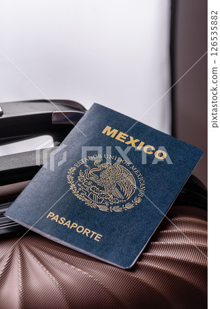 International passport of a citizen of Mexico on a suitcase International passport of a citizen of Mexico on a suitcase 126535882