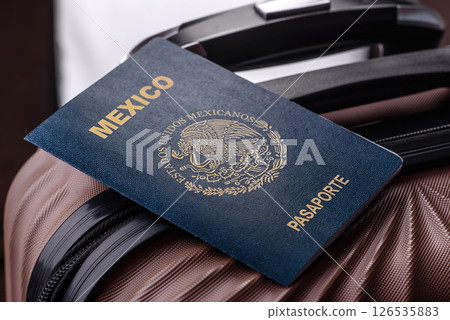 International passport of a citizen of Mexico on a suitcase International passport of a citizen of Mexico on a suitcase 126535883