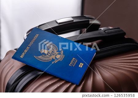 International passport of a citizen of Indonesia on a suitcase International passport of a citizen of Indonesia on a suitcase 126535958