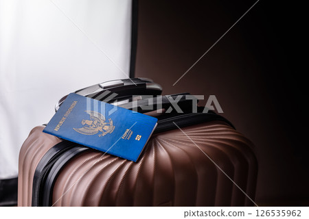 International passport of a citizen of Indonesia on a suitcase International passport of a citizen of Indonesia on a suitcase 126535962