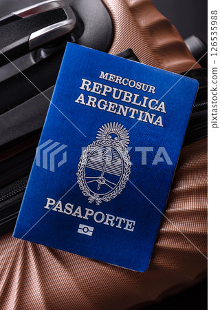 International passport of a citizen of Argentina on a suitcase 126535988