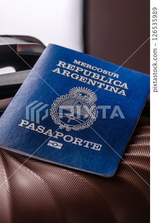 International passport of a citizen of Argentina on a suitcase 126535989