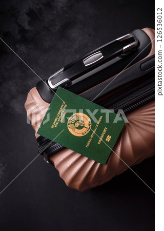 International passport of a citizen of Nigeria on a suitcase 126536012