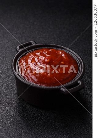 Red sauce or ketchup with salt and spices in ceramic sauce boat 126536077