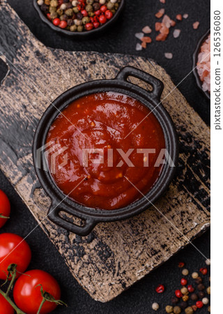 Red sauce or ketchup with salt and spices in ceramic sauce boat Red sauce or ketchup with salt and spices in ceramic sauce boat 126536080