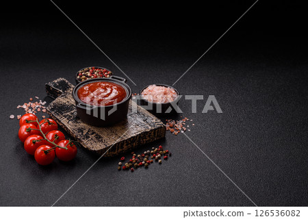 Red sauce or ketchup with salt and spices in ceramic sauce boat 126536082