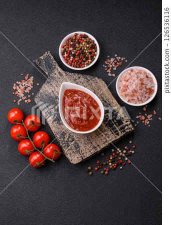 Red sauce or ketchup with salt and spices in ceramic sauce boat Red sauce or ketchup with salt and spices in ceramic sauce boat 126536116