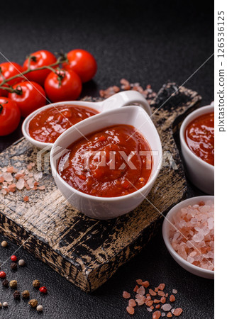 Red sauce or ketchup with salt and spices in ceramic sauce boat Red sauce or ketchup with salt and spices in ceramic sauce boat 126536125