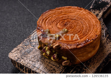 Round puff pastry croissant with pistachio filling or new york roll Round puff pastry croissant with pistachio filling or new york roll 126536135