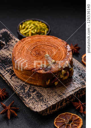Round puff pastry croissant with pistachio filling or new york roll Round puff pastry croissant with pistachio filling or new york roll 126536140