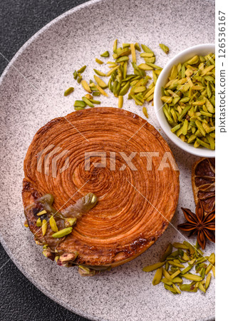 Round puff pastry croissant with pistachio filling or new york roll 126536167