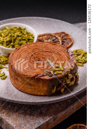 Round puff pastry croissant with pistachio filling or new york roll Round puff pastry croissant with pistachio filling or new york roll 126536172