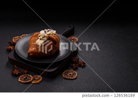 Sweet crispy fresh croissant with berry filling Sweet crispy fresh croissant with berry filling 126536189